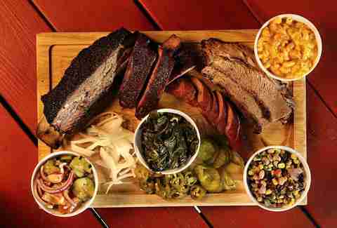 barbecue platter with onions, collard greens, cowboy caviar and mac and cheese